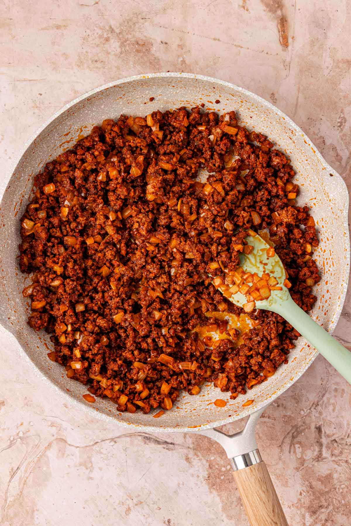 Ground beef with seasonings in a skillet.