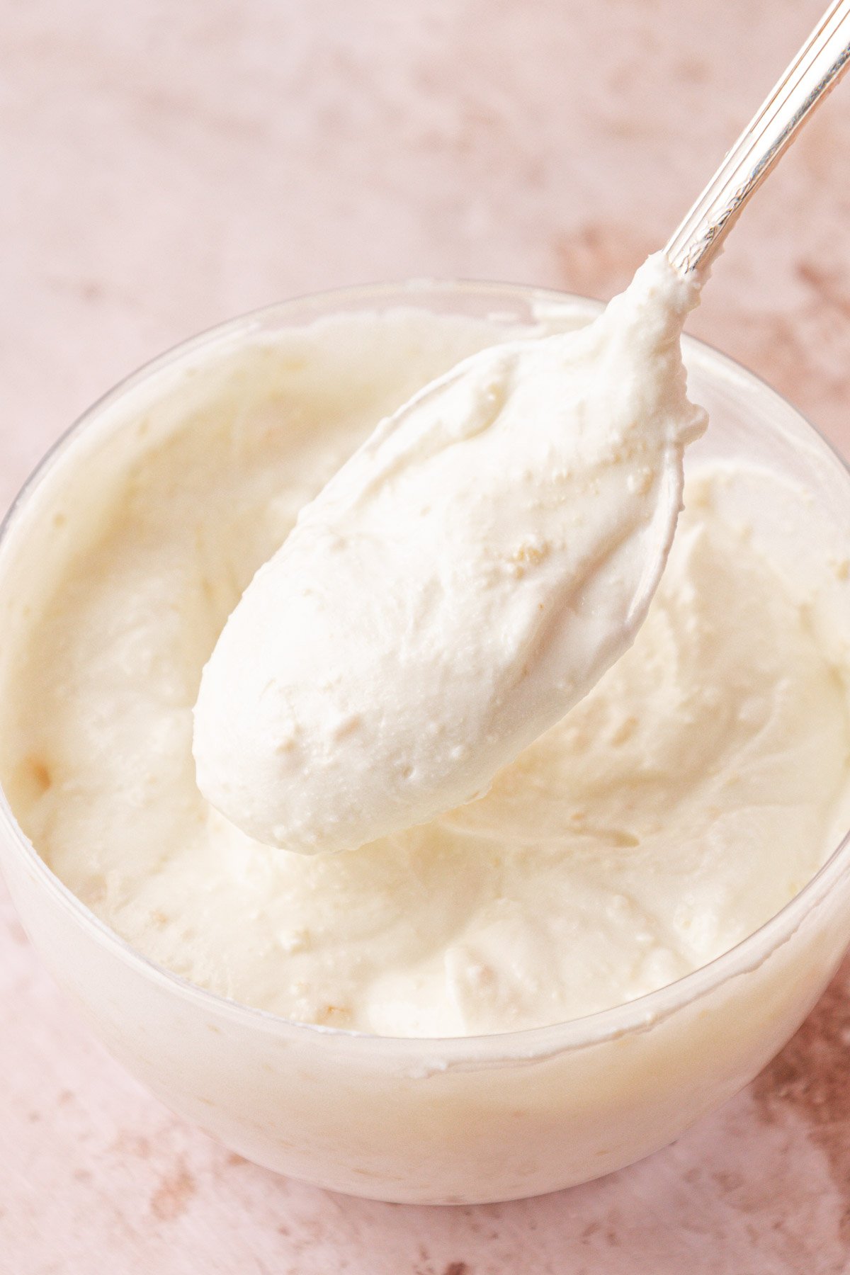 Lemon garlic yogurt sauce in a bowl with a spoon scooping into it.